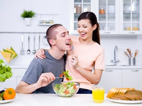 The girl feeds her husband with the product to increase potency